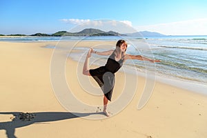 Girl, sand, balance posture in yoga,