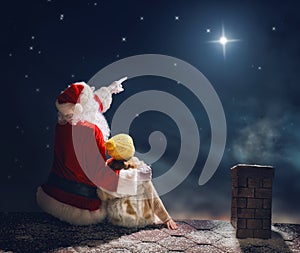 Girl and Santa Claus sitting on the roof