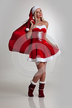 Girl in santa dress with gift bag