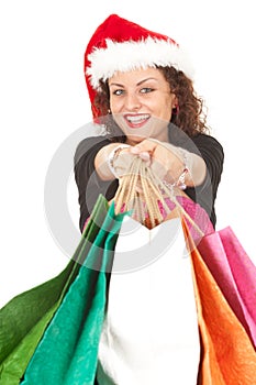 Girl in Santa hat carrying shopping bags