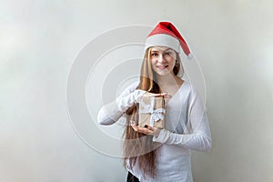 Girl in Santa hat with chrismass gift