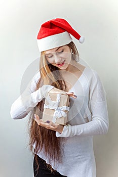 Girl in Santa hat with chrismass gift