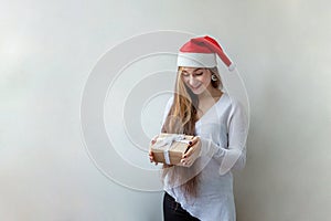 Girl in Santa hat with chrismass gift