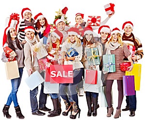 Girl in Santa hat holding Christmas gift box.