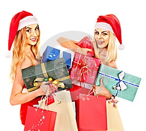 Girl in Santa hat holding Christmas gift box.