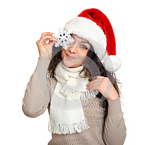 Girl in santa hat portrait with snowflake posing on white background, christmas holiday concept, happy and emotions