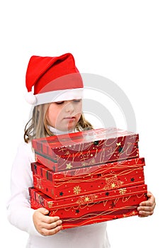 Girl in Santa's red hat carrying three presents