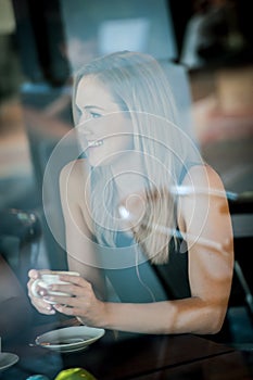 Girl sat in the window of a coffee shop