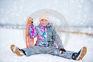 Girl with saucer sled on the snow