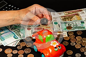 Girl saves money invests in a piggi bank standing on the table