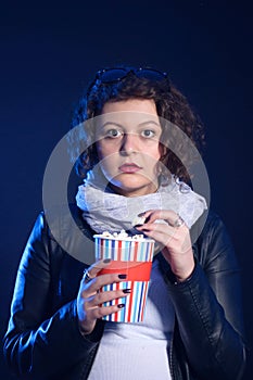 Girl scared at the cinema, watching horror movie