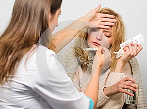 Girl in scarf examined by doctor. Cold and flu remedies. Woman consult with doctor. Doctor communicate with patient