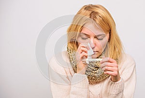 Girl in scarf hold thermometer and tissue close up. Cold and flu remedies. High temperature concept. Take temperature