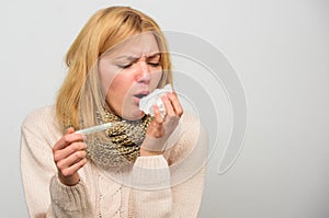 Girl in scarf hold thermometer and tissue close up. Cold and flu remedies. Take temperature and assess symptoms. Measure