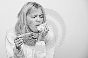 Girl in scarf hold thermometer and tissue close up. Cold and flu remedies. Take temperature and assess symptoms. Measure