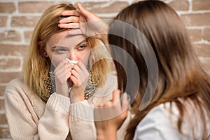 Girl in scarf hold tissue while doctor examine her. Recognize symptoms of cold. Remedies should help beat cold fast