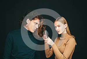 Girl scheming an evil plan of cutting off a curly hair in a man. A smart wily woman has wonderful schemes like a crook