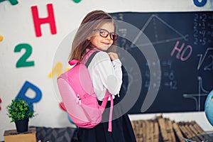 Girl with a school backpack. The concept of school, study, education, friendship, childhood.