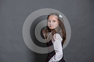 Girl in school uniform standing at the chalkboard