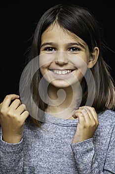 Girl, schoolgirl meditates, expresses emotions, close-up on a black background