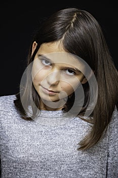 Girl, schoolgirl meditates, expresses emotions, close-up on a black background