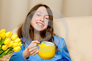 Girl schoolgirl with a mug in her hands.