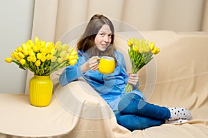 Girl schoolgirl with a mug in her hands.