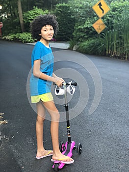 Girl on scooter during pandemic with masks