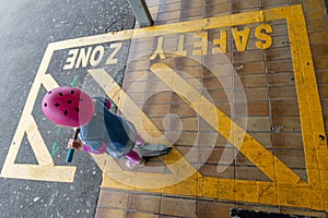 Girl with scooter at train station 16