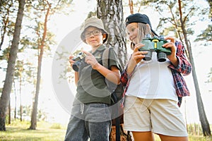 Girl scout frying marshmallows on fire at the woods.