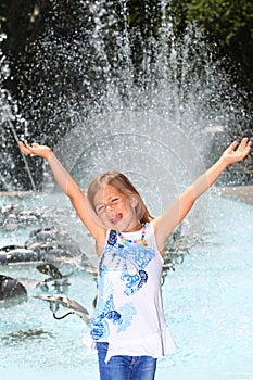 Girl screaming with delight by fountain