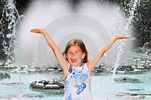 Girl screaming with delight by fountain