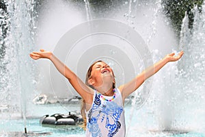 Girl screaming with delight by fountain photo