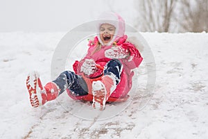 A girl screaming and shrieking ice slides down hill