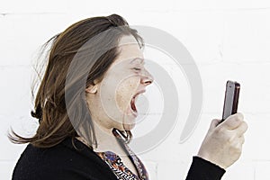 Girl screaming to mobile