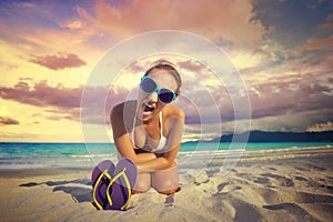 The girl screams at the camera against beautiful tropical beach