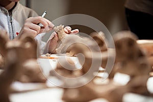 Girl sculpts from clay kitten