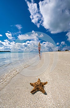 Girl on seashore and starfish photo