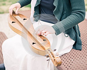 Girl Seated Playing Mountain Dulcimer photo