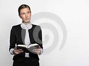 Girl secretary in office clothes with book