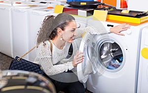 Girl selecting new washing machine