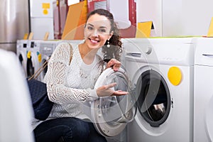 Girl selecting new washing machine