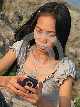 Girl sending SMS from holidays