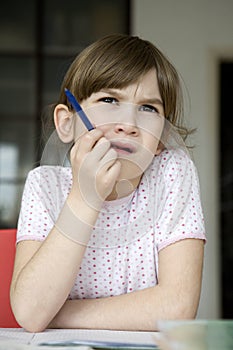 girl seven years old doing homework.