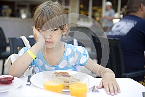 Girl seven years old eats a pancake