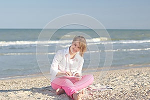 Girl seventeen-year-old with Down syndrome on the beach play wi