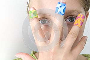 Girl with several colorful bandages
