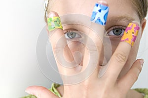 Girl with several colorful bandages photo