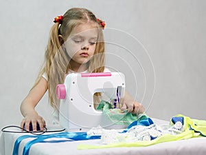 Girl sewing on the sewing machine