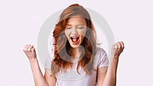 Girl Shaking Fists In Joy Celebrating Victory On White Background